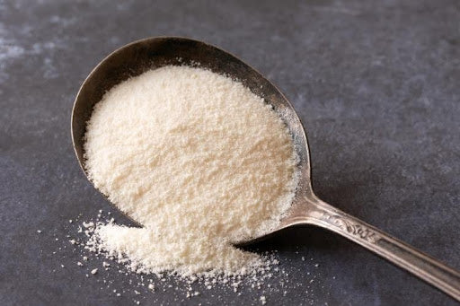 Collagen powder on a silver spoon